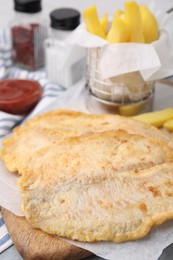 Photo of Delicious fish and chips on table, closeup