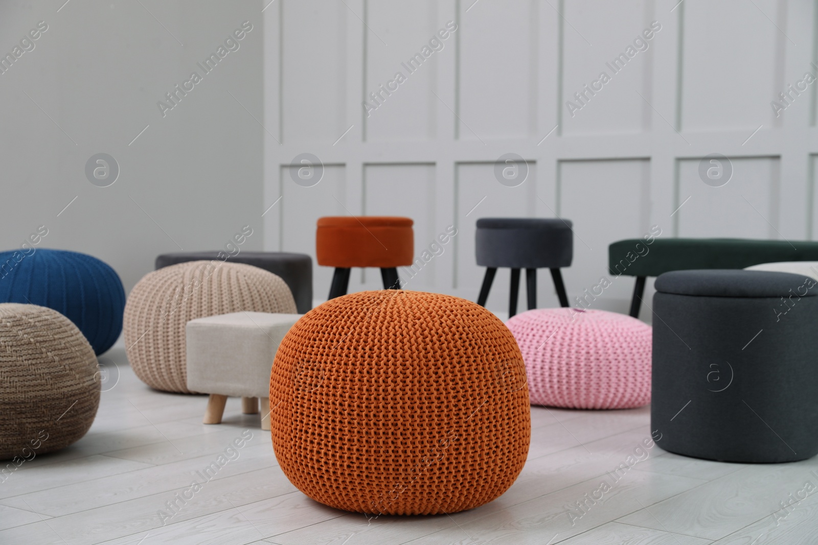 Photo of Different stylish poufs and ottomans in room