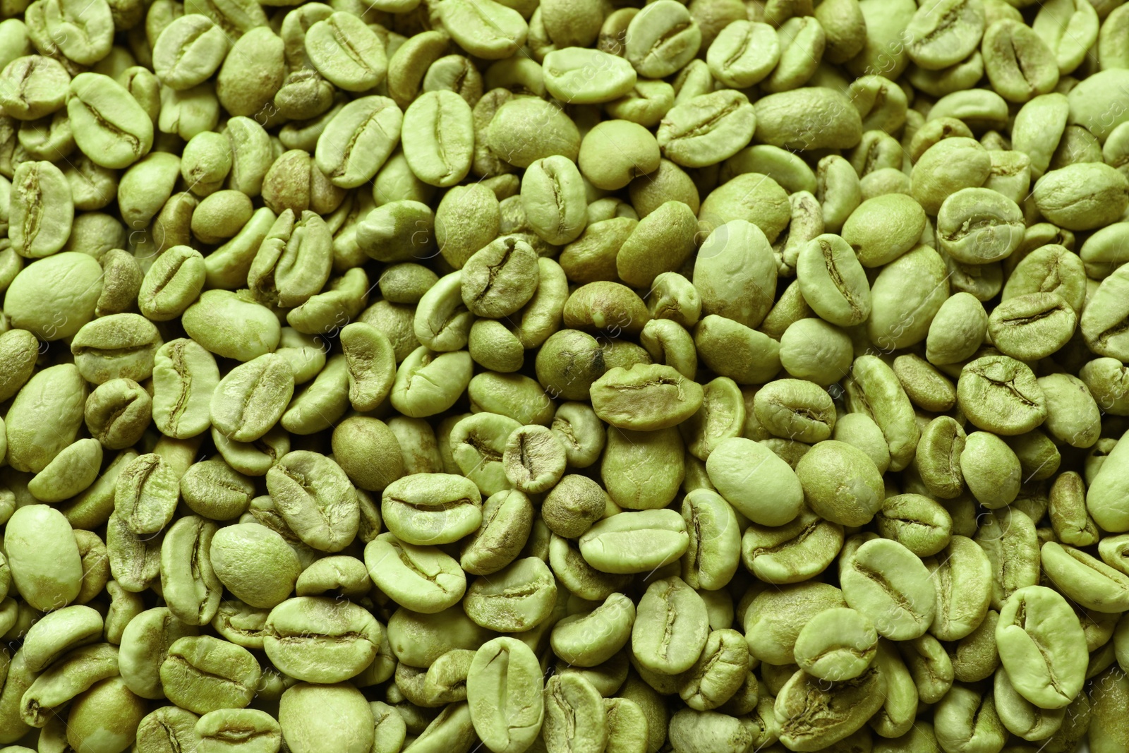 Photo of Many green coffee beans as background, top view