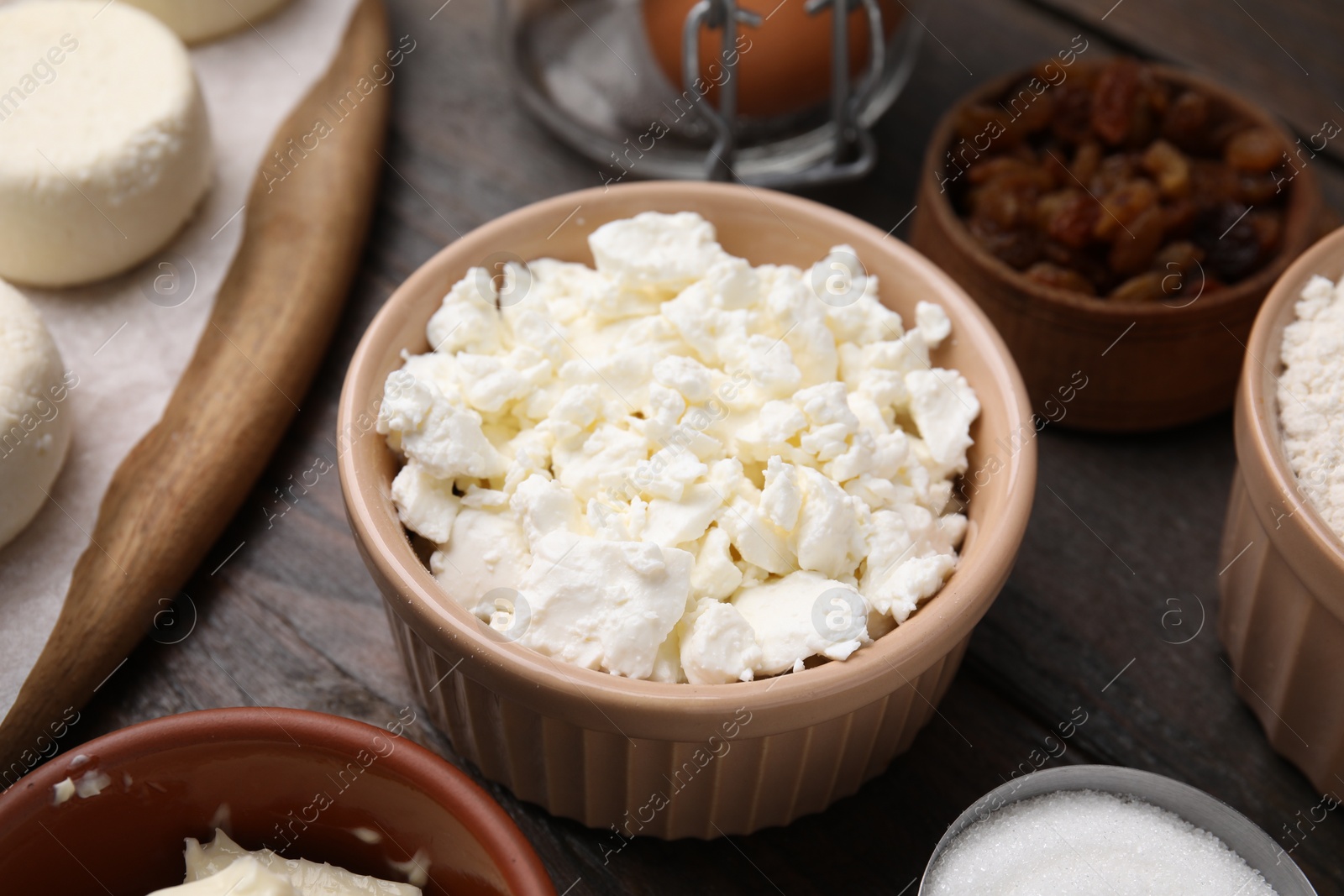 Photo of Different ingredients on wooden table, closeup. Cooking cottage cheese pancakes