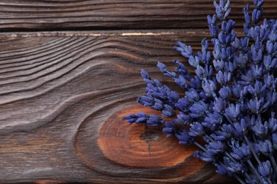 Photo of Bouquet of beautiful preserved lavender flowers on wooden table, top view. Space for text