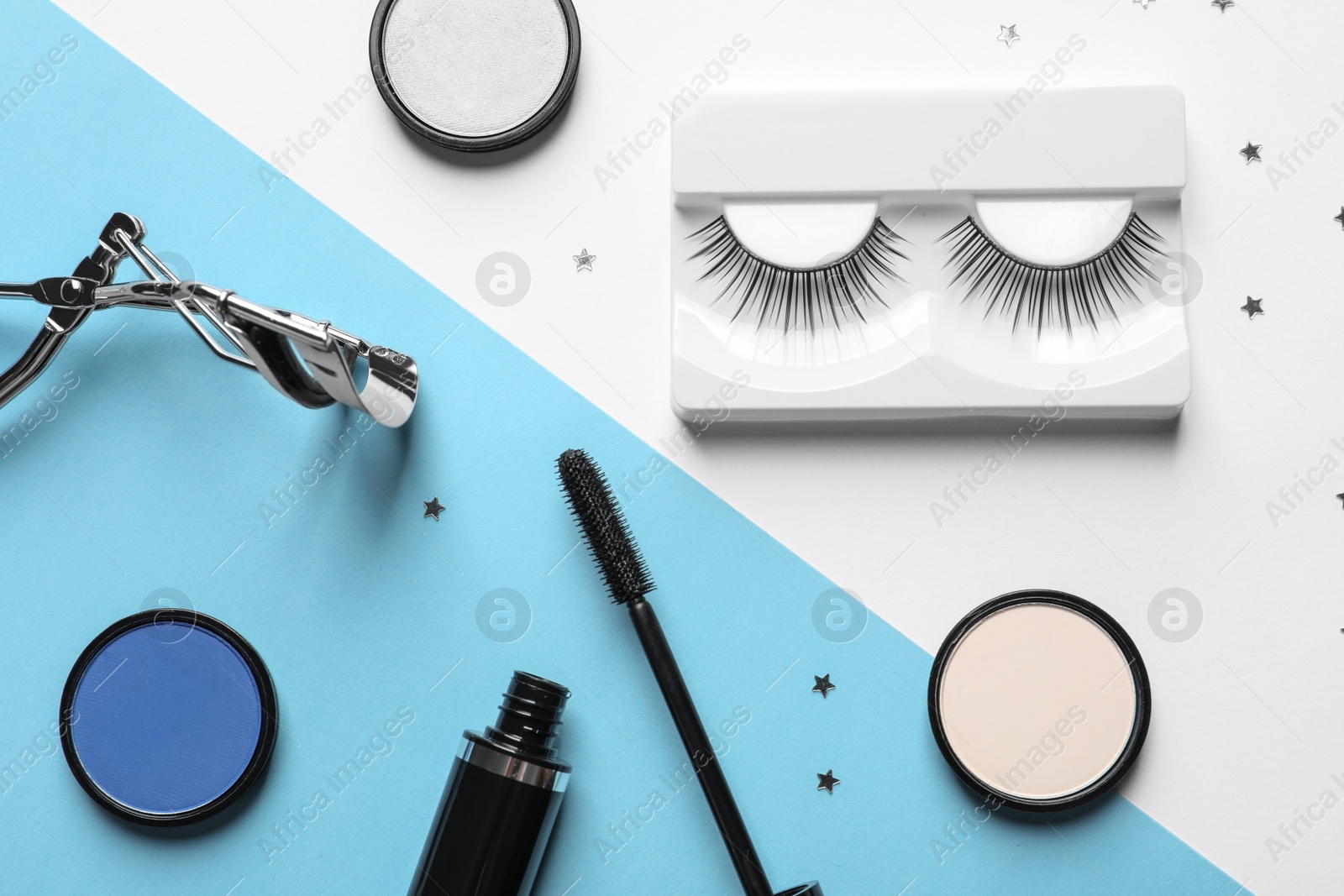 Photo of Flat lay composition with false eyelashes and other makeup products on color background