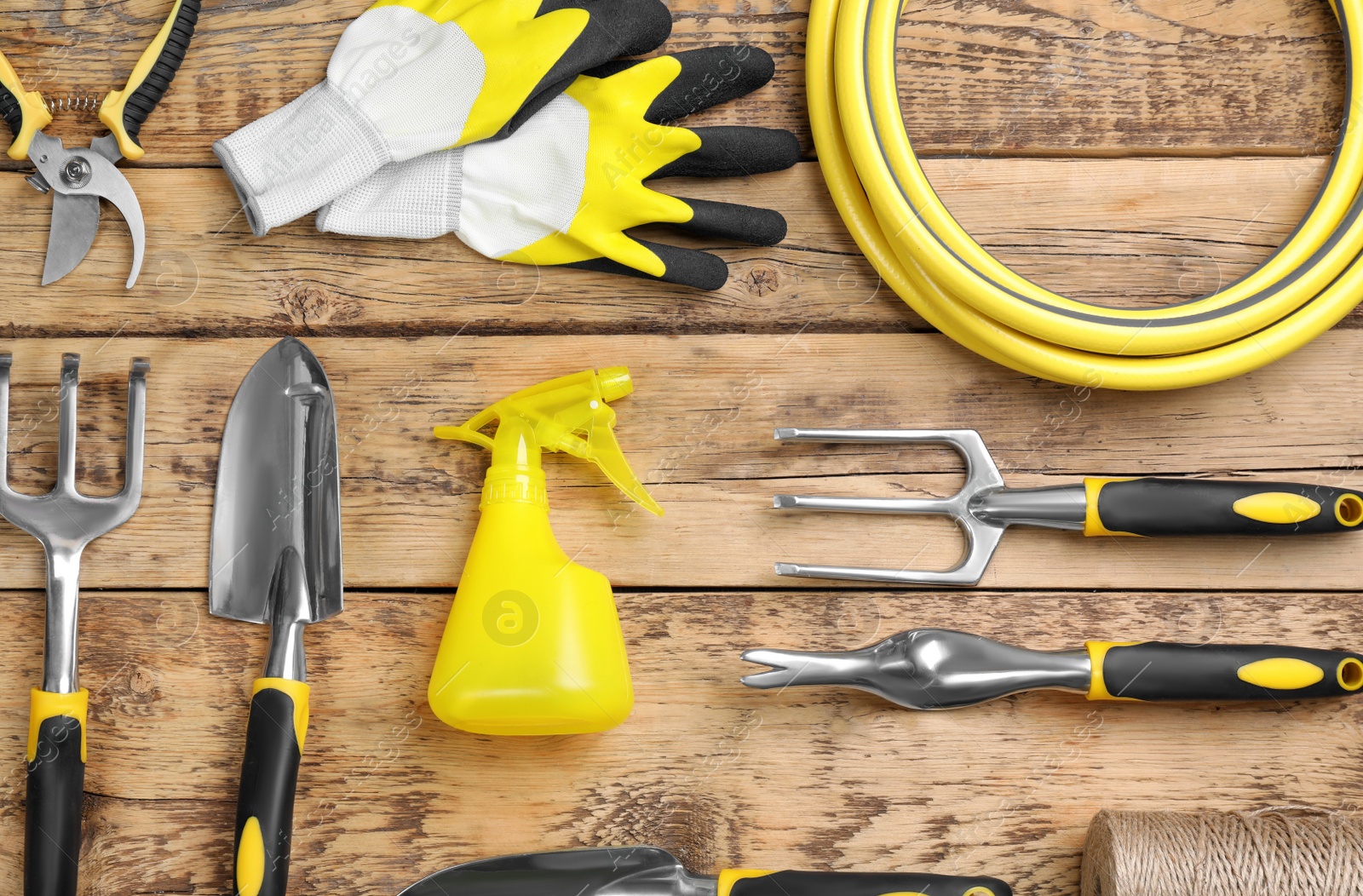 Photo of Flat lay composition with gardening tools on wooden background