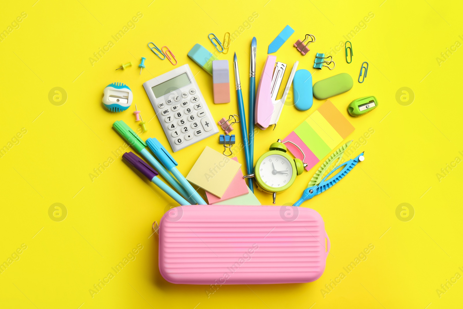 Photo of Flat lay composition with school stationery on yellow background. Back to school