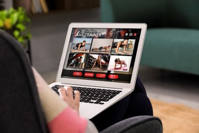 Personal trainer online. Man viewing website via laptop at home, closeup