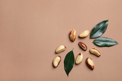 Photo of Flat lay composition with Brazil nuts and space for text on color background