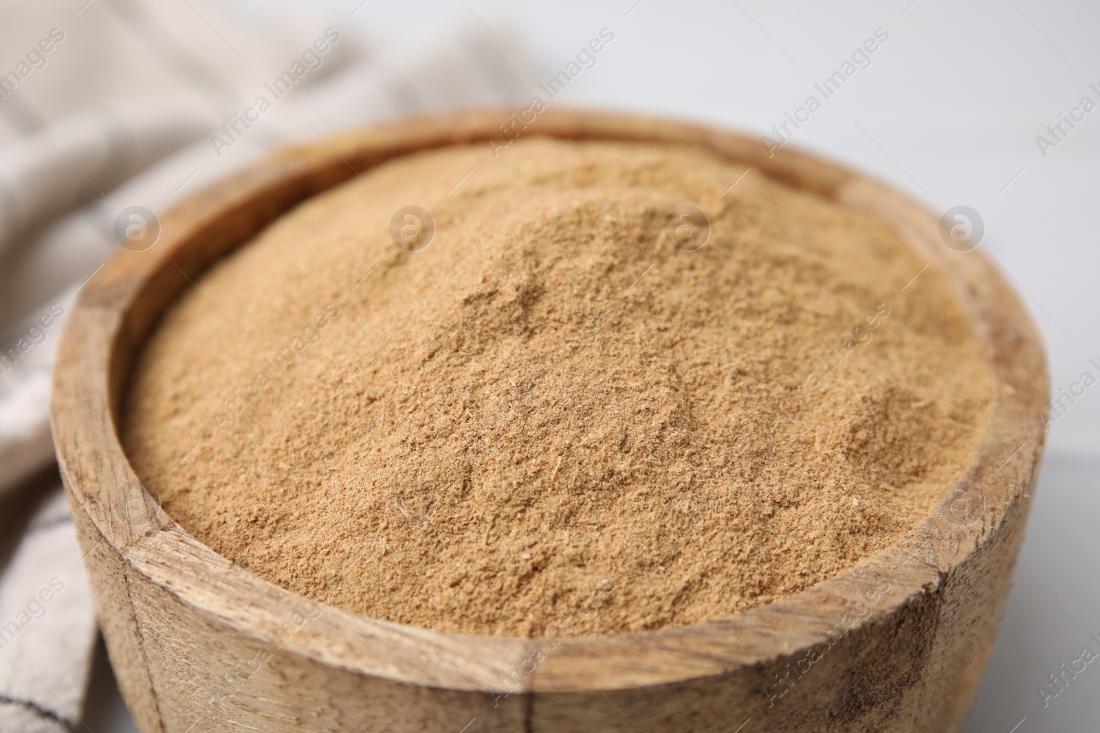 Photo of Dietary fiber. Psyllium husk powder in bowl on white table