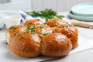 Photo of Traditional Ukrainian garlic bread (Pampushky) on table, closeup