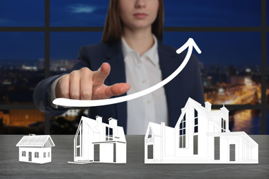 Real estate agent demonstrating prices at housing market. Woman pointing on graph illustration, closeup