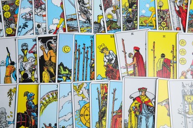Photo of Many different tarot cards as background, top view
