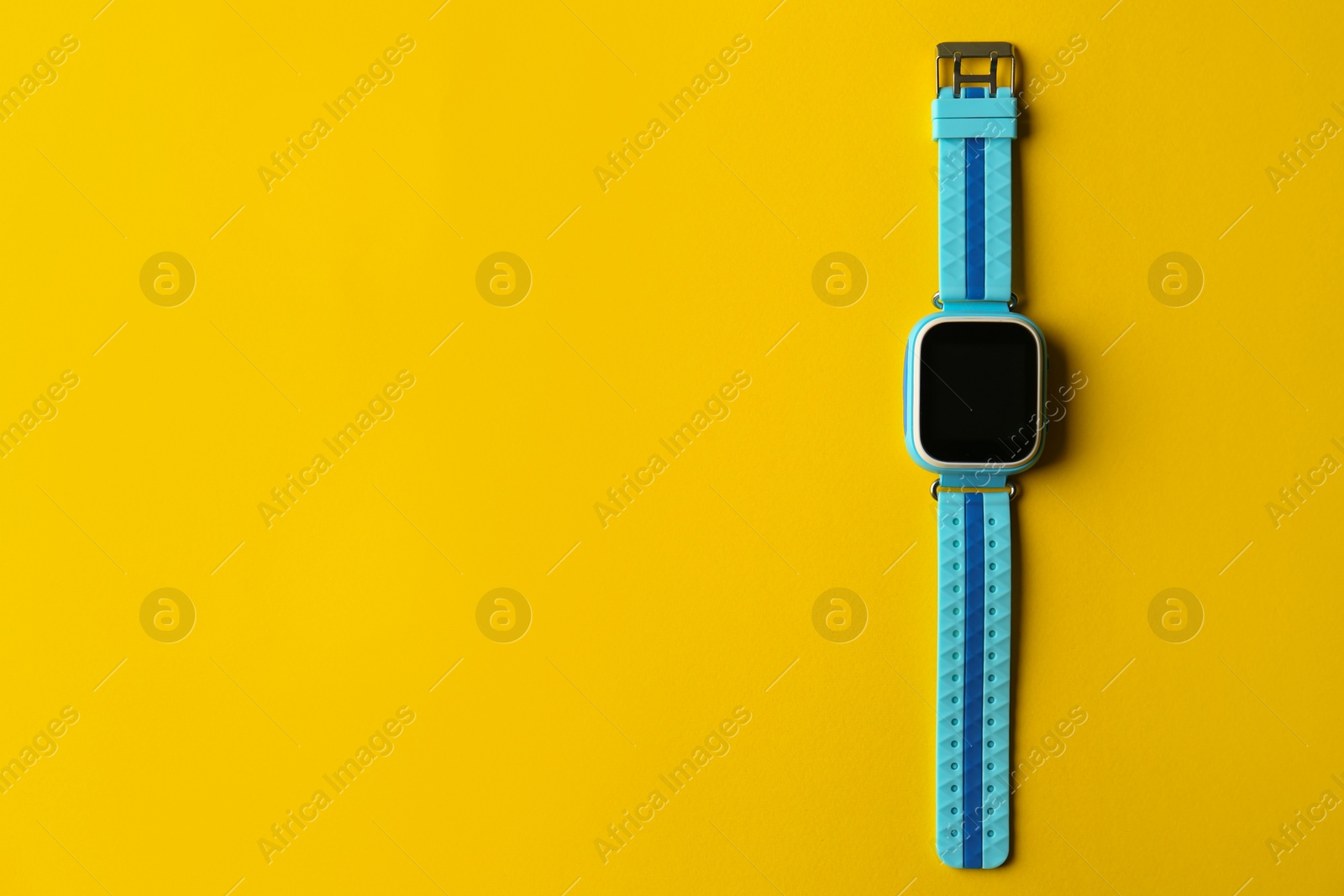Photo of Kid smart watch on yellow background, top view. Space for text