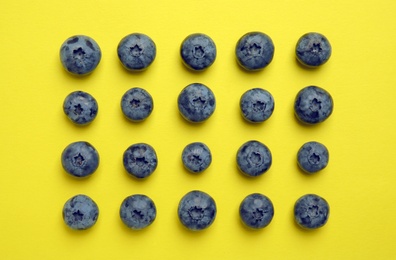 Photo of Flat lay composition with tasty blueberry on color background