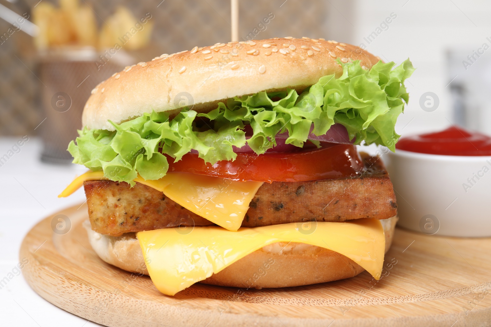 Photo of Delicious burger with tofu and fresh vegetables on white table, closeup