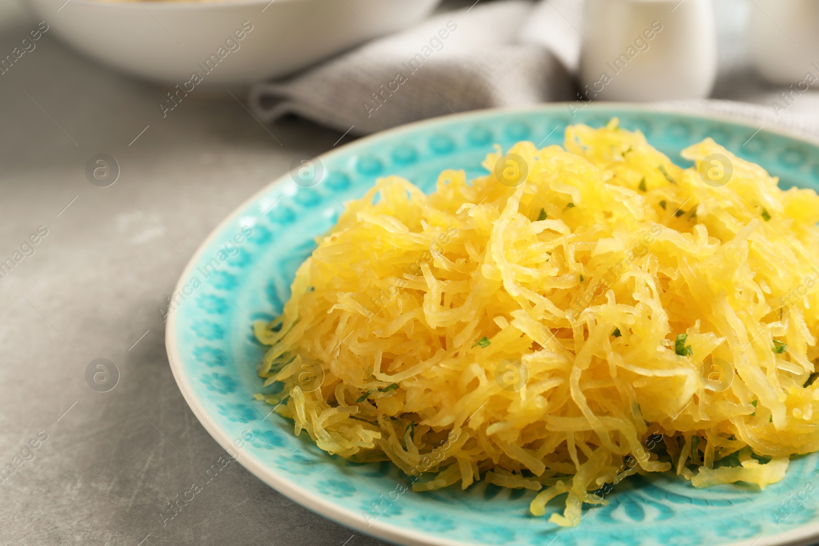 Photo of Plate with cooked spaghetti squash on table