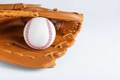 Photo of Catcher's mitt and baseball ball on white background, space for text. Sports game