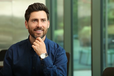 Portrait of handsome stylish man in office