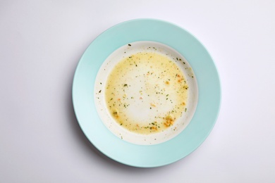 Photo of Dirty plate with food leftovers on white background, top view