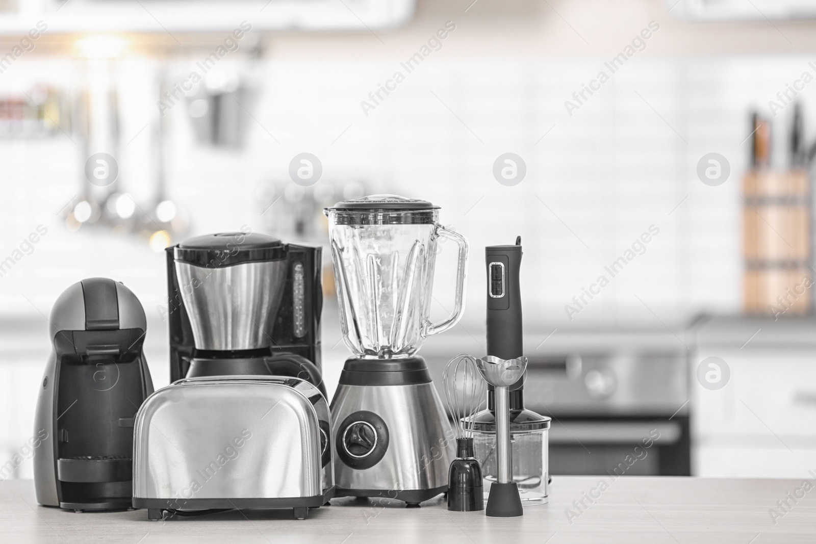 Photo of Different modern kitchen appliances on table indoors. Interior element