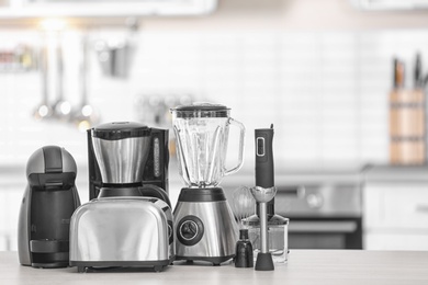 Photo of Different modern kitchen appliances on table indoors. Interior element