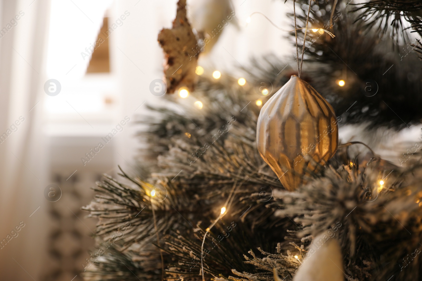 Photo of Beautiful decorated Christmas tree with fairy lights in room, closeup