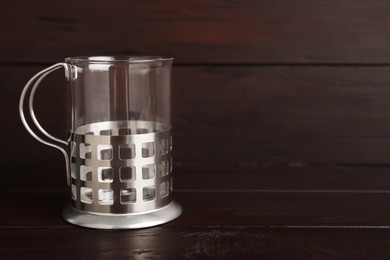 Photo of Traditional tea glass holder on wooden table, space for text