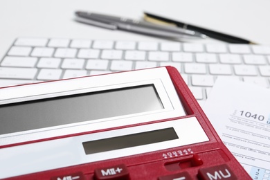 Photo of Calculator, keyboard and document on table, closeup. Tax accounting