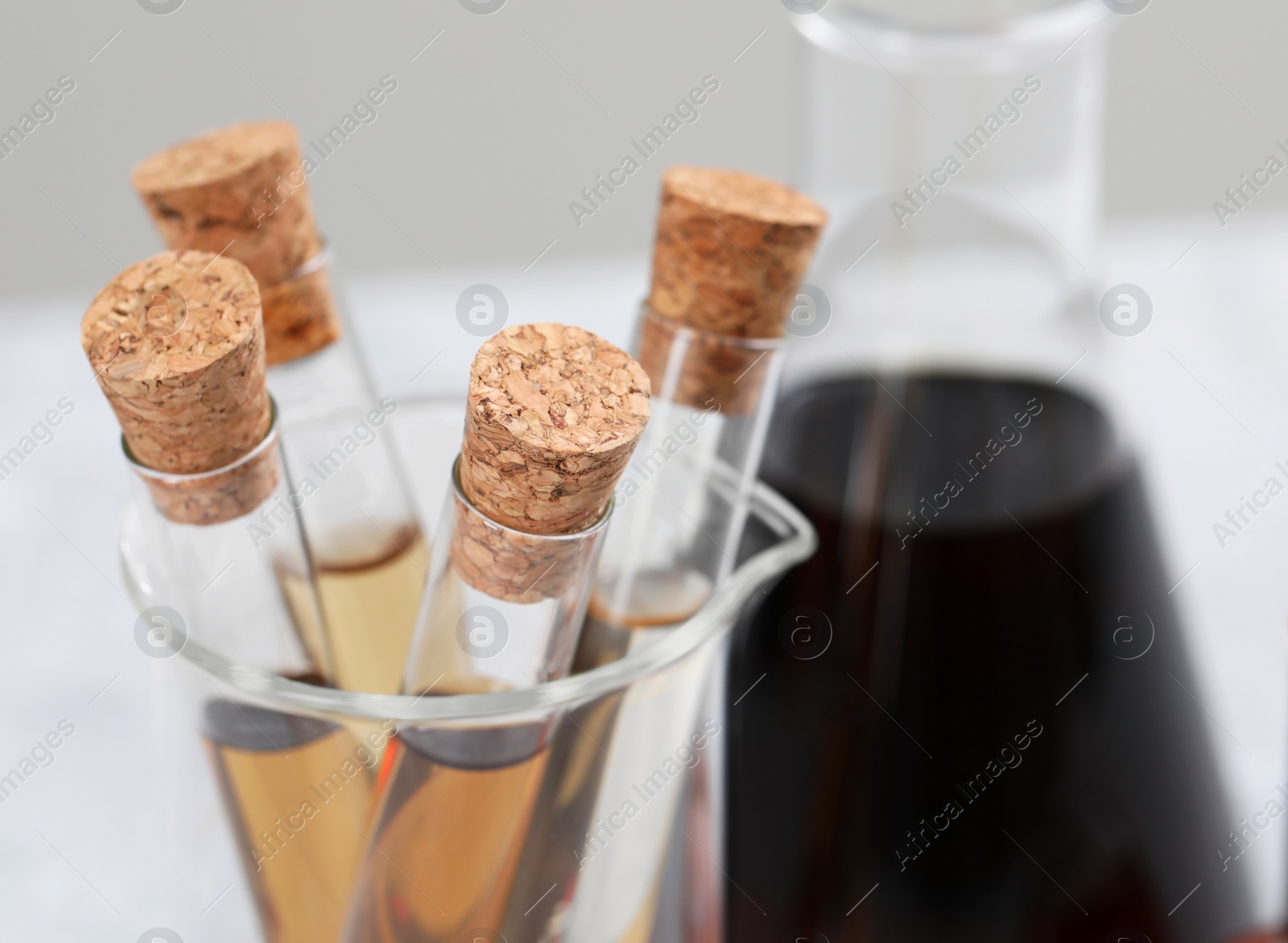 Photo of Test tubes with brown liquid, closeup. Space for text