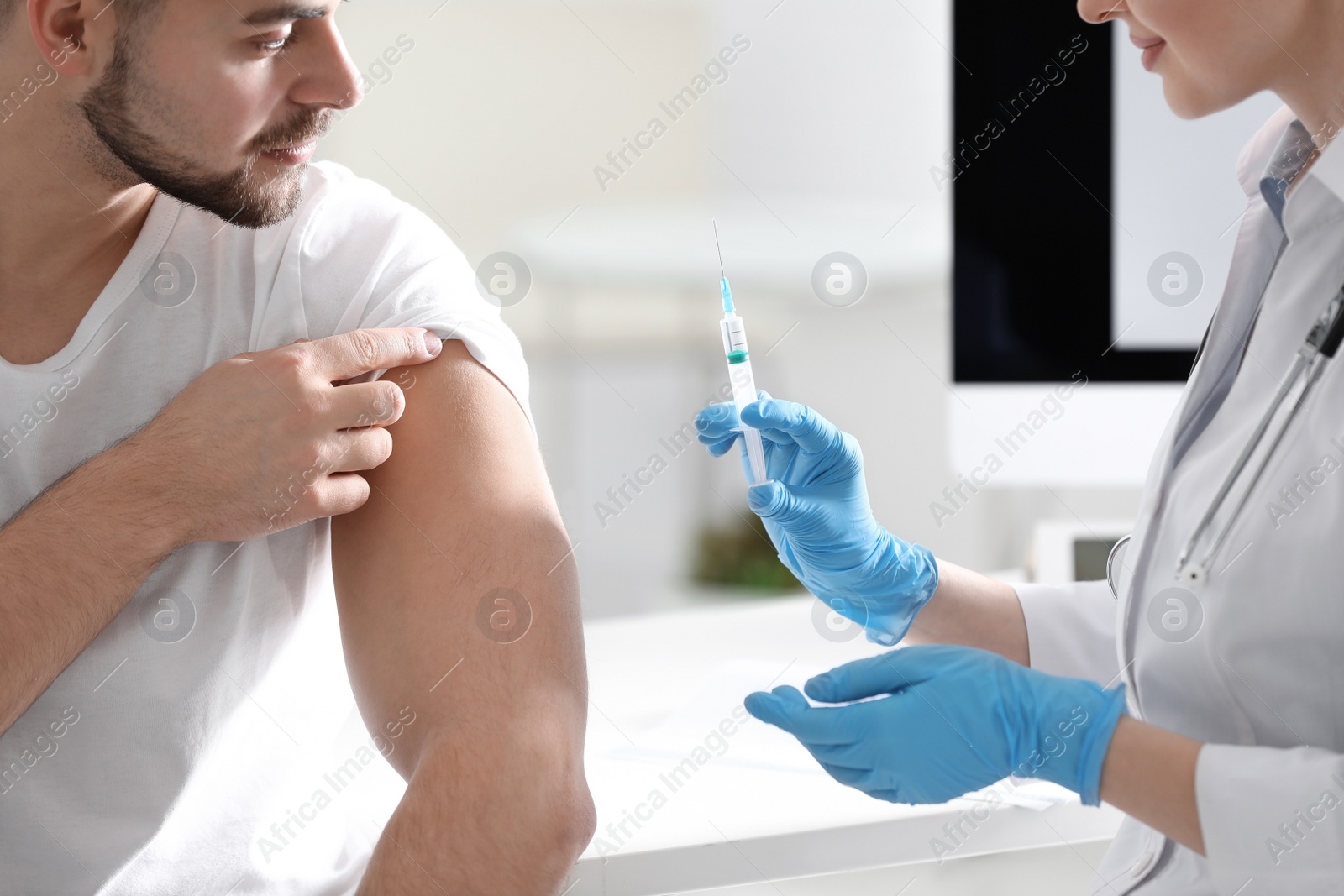 Photo of Doctor giving injection to patient in hospital, closeup. Vaccination concept