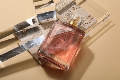 Photo of Stylish presentation of luxury women`s perfume in sunlight on beige background