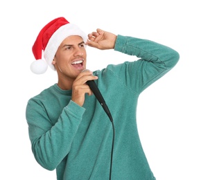 Photo of Emotional man in Santa Claus hat singing with microphone on white background. Christmas music