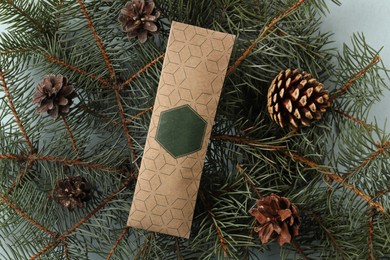 Scented sachet, pine cones and fir branches on grey background, flat lay
