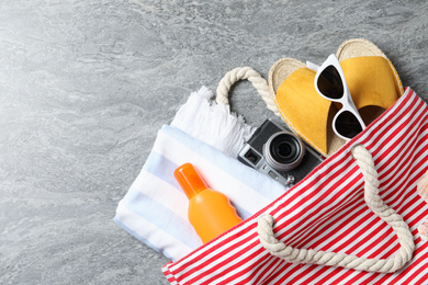 Flat lay composition with vintage camera and beach objects on grey stone background
