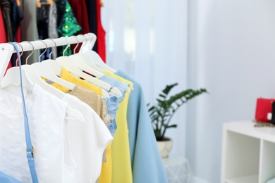 Photo of Rack with stylish clothes in boutique, closeup. Space for text