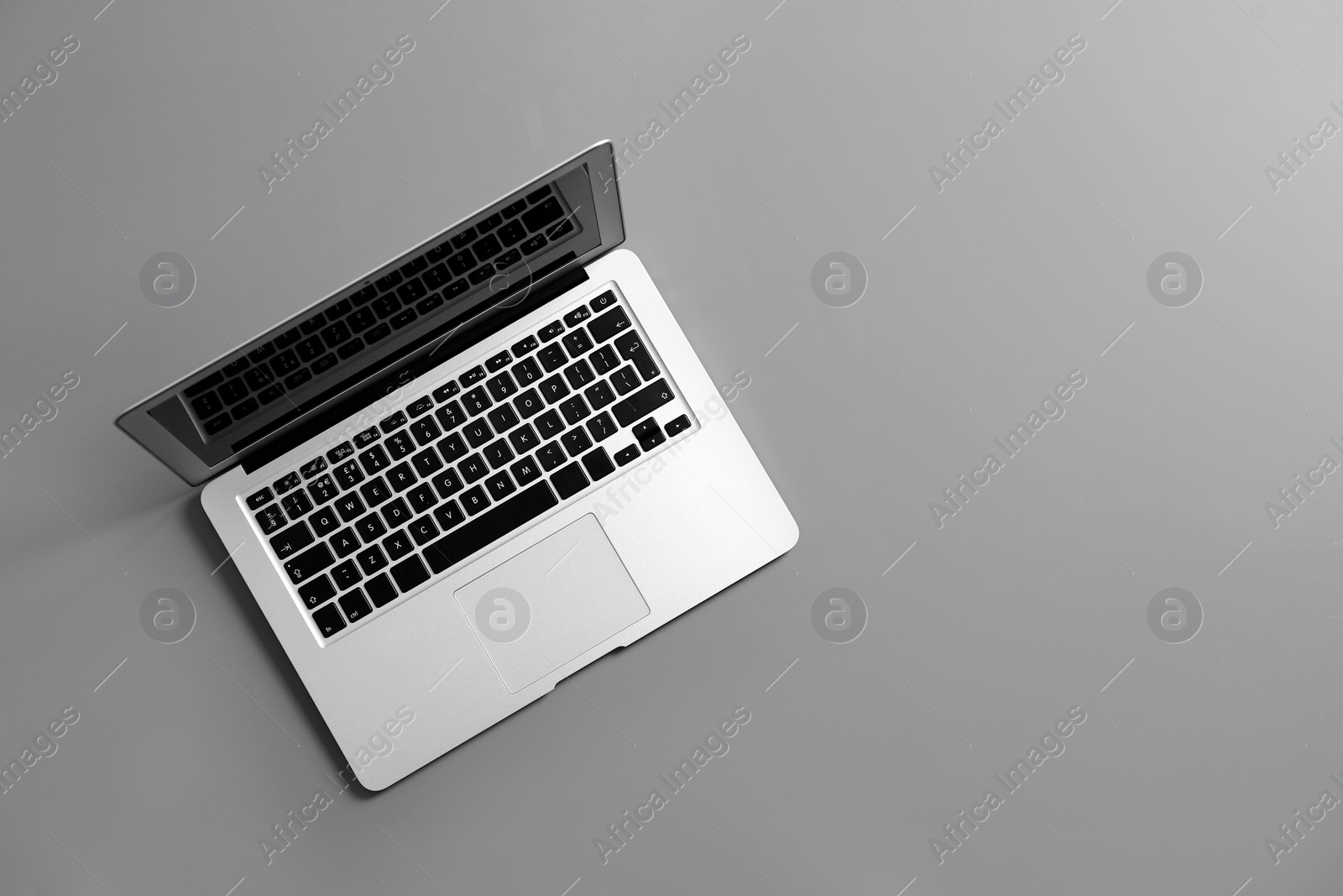 Photo of Modern laptop on gray background, top view