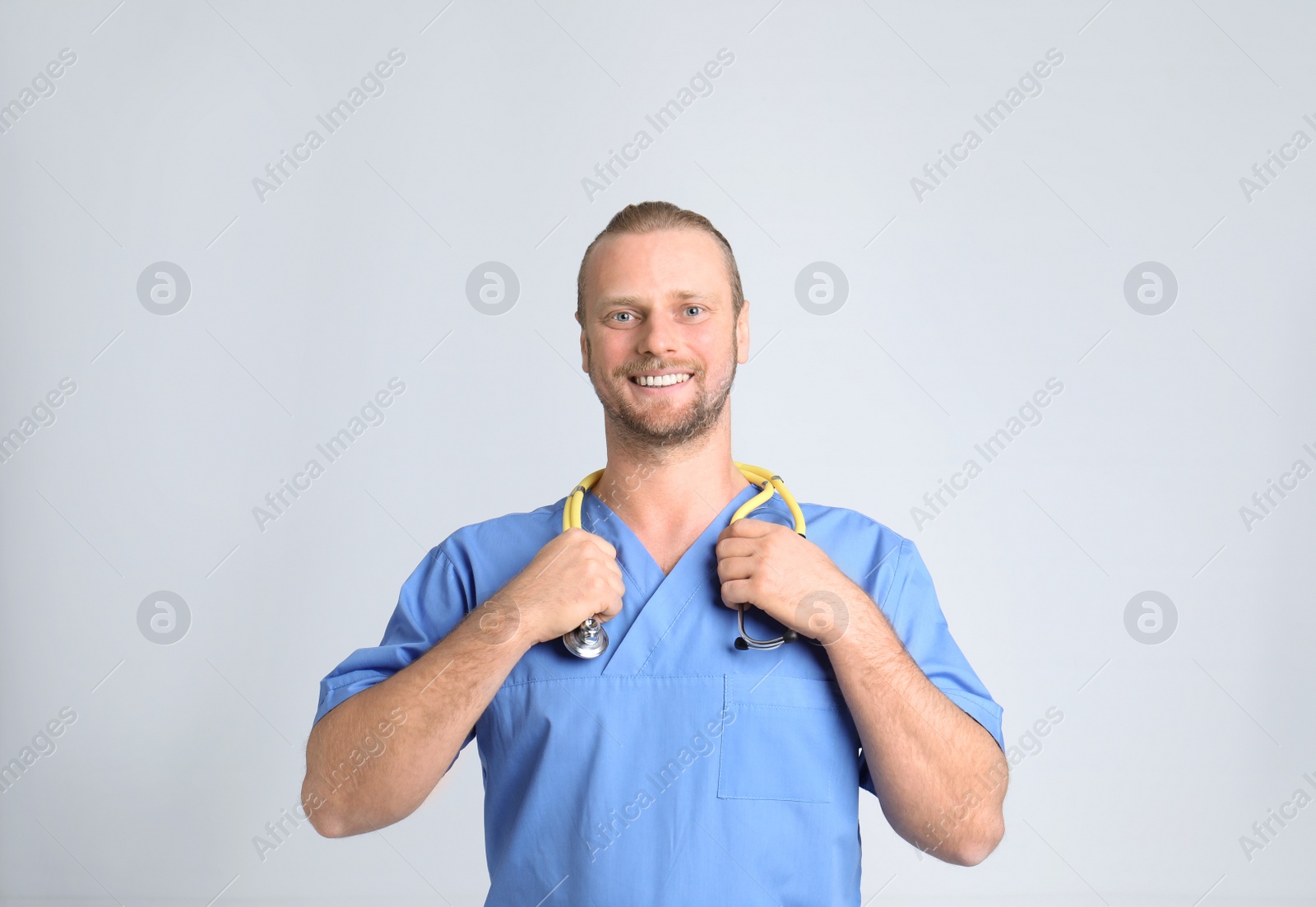 Photo of Portrait of medical assistant with stethoscope on color background