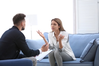 Male psychologist with client in office