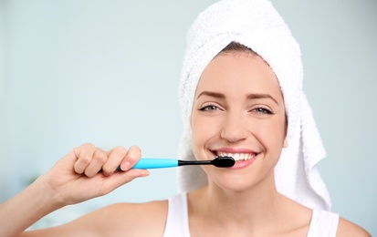 Photo of Portrait of young woman with toothbrush on blurred background