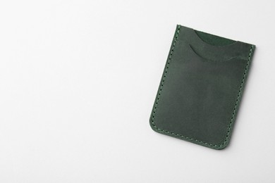 Photo of Empty leather card holder on light grey background, top view. Space for text