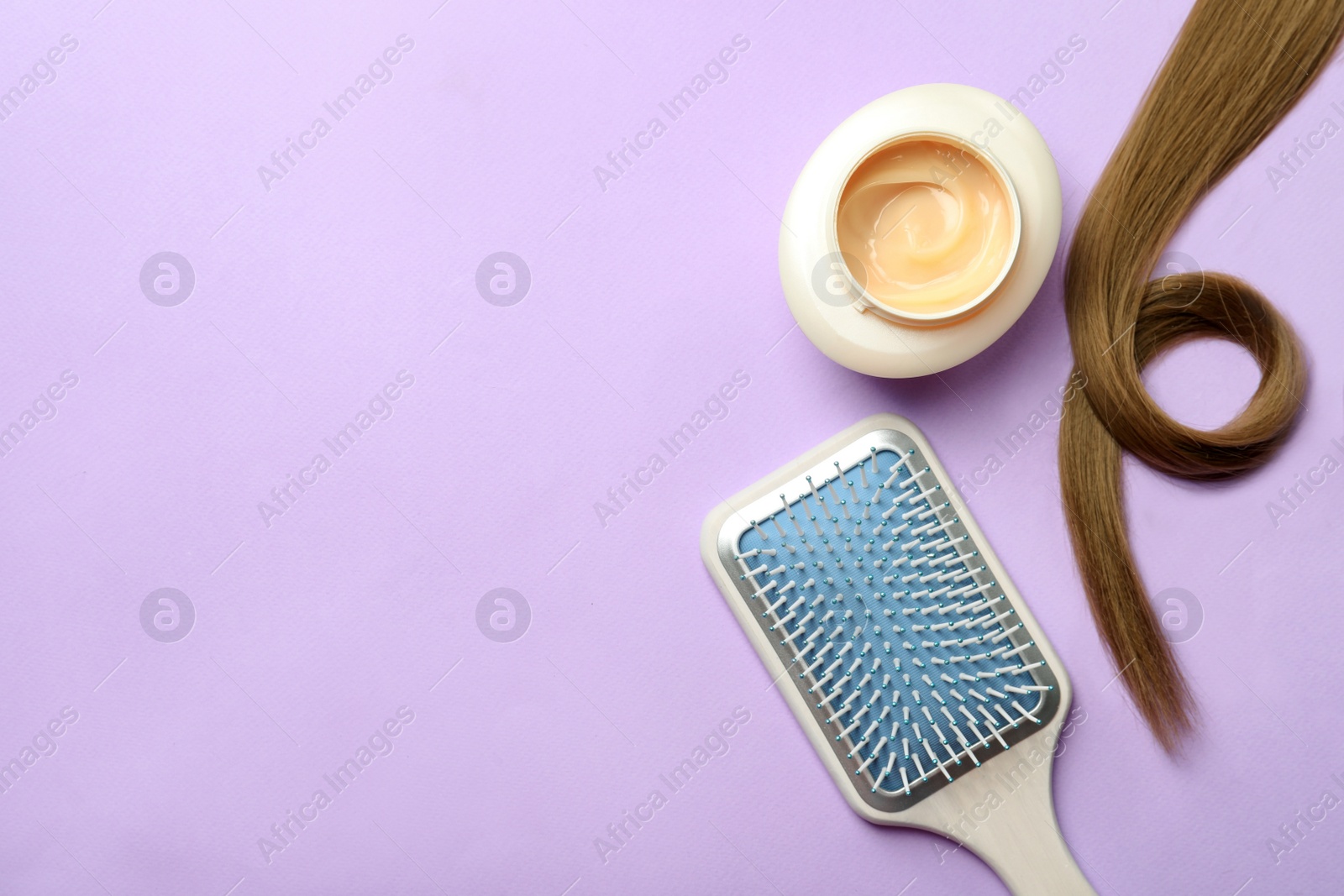 Photo of Jar of cosmetic product, brush and hair lock on violet background, flat lay. Space for text