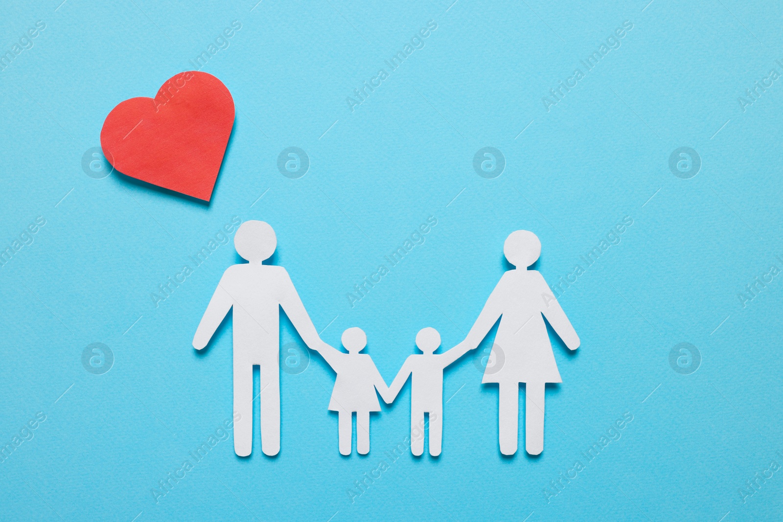 Photo of Paper family figures and red heart on light blue background, flat lay. Insurance concept