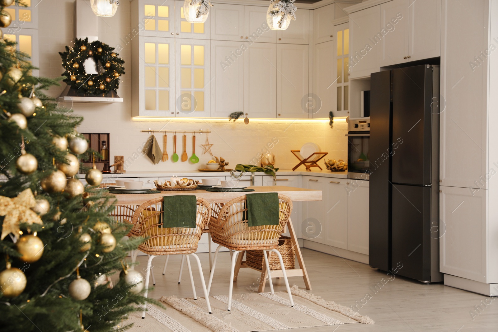 Photo of Cozy open plan kitchen decorated for Christmas. Interior design