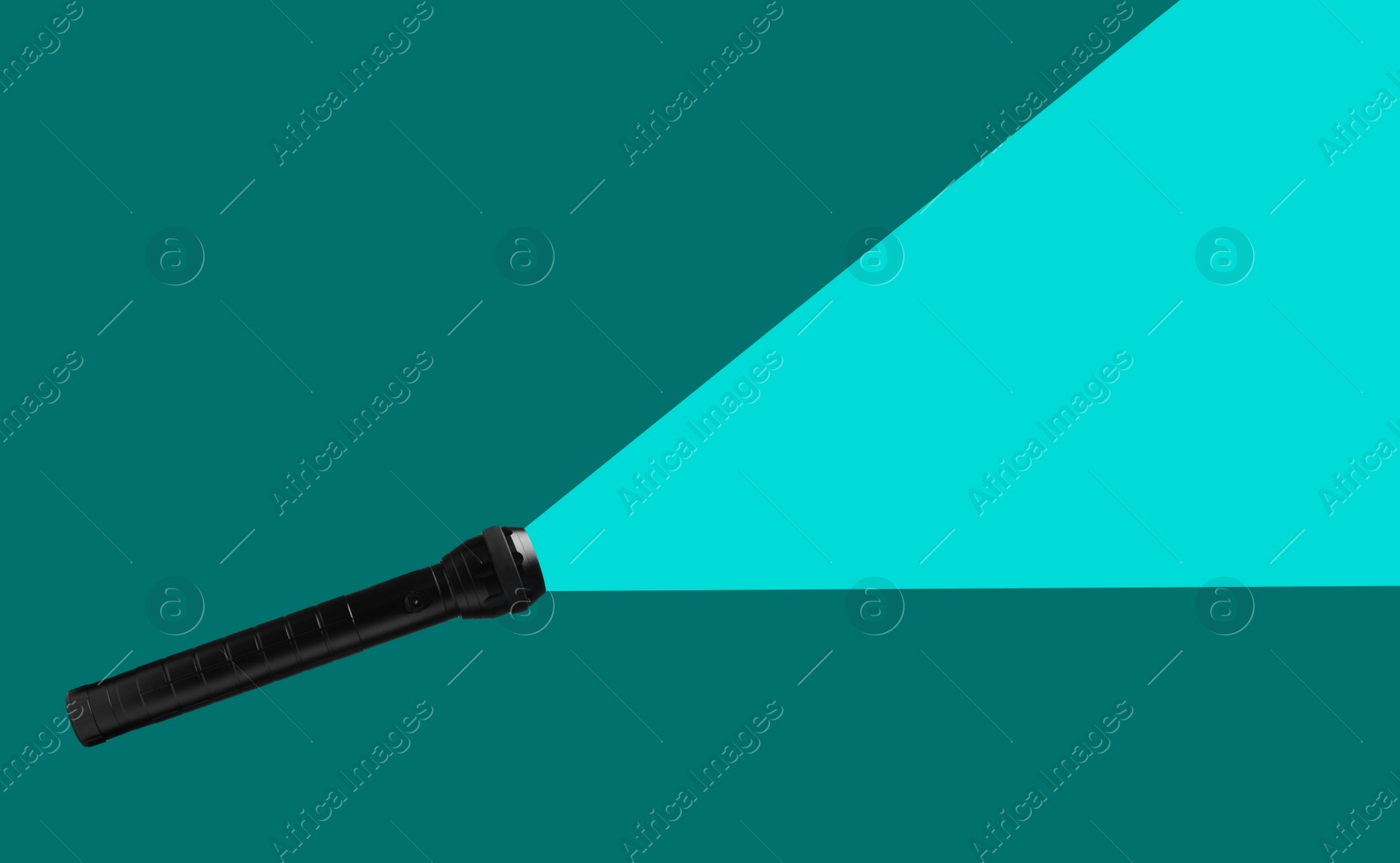 Image of Flashlight illuminating turquoise background. Light symbolizing search, guidance, direction and other