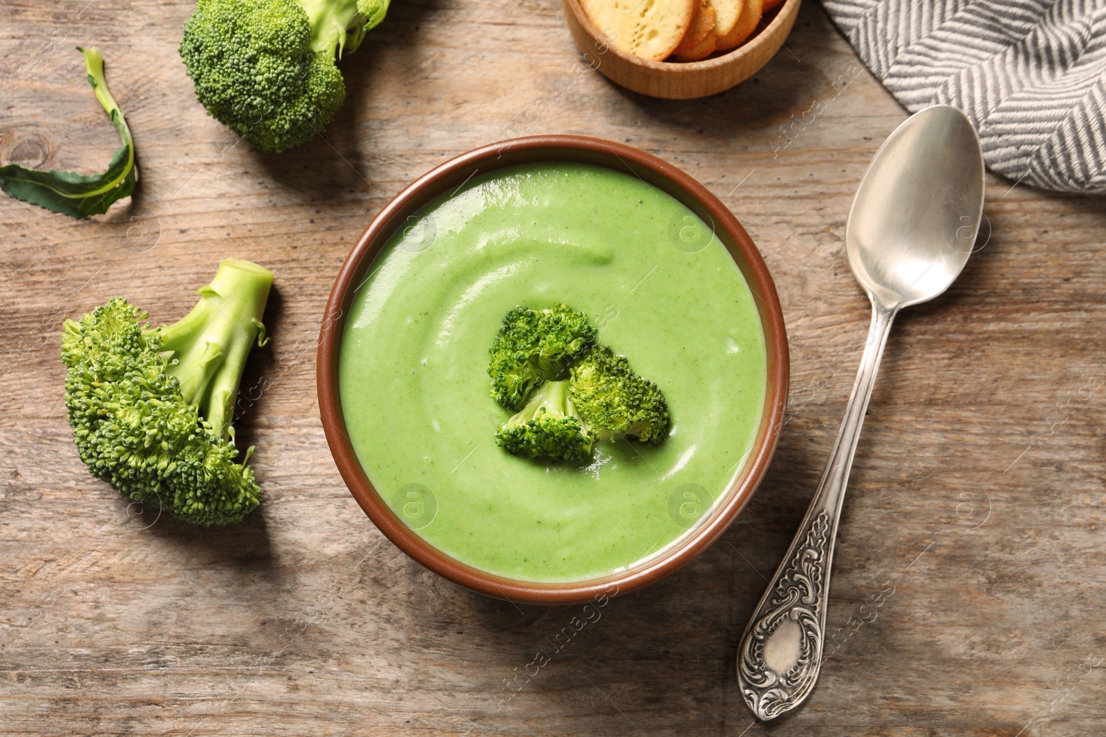 Photo of Fresh vegetable detox soup made of broccoli in dish served on table, top view