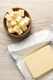 Photo of Tasty butter on light wooden table, flat lay