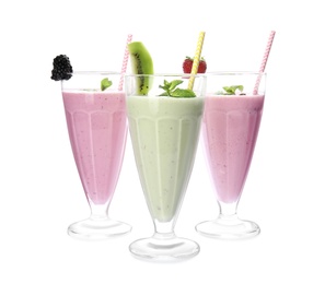 Photo of Tasty fresh milk shakes with berries on white background