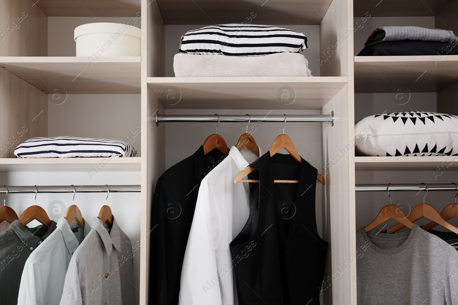 Photo of Stylish clothes and home stuff in large wardrobe closet