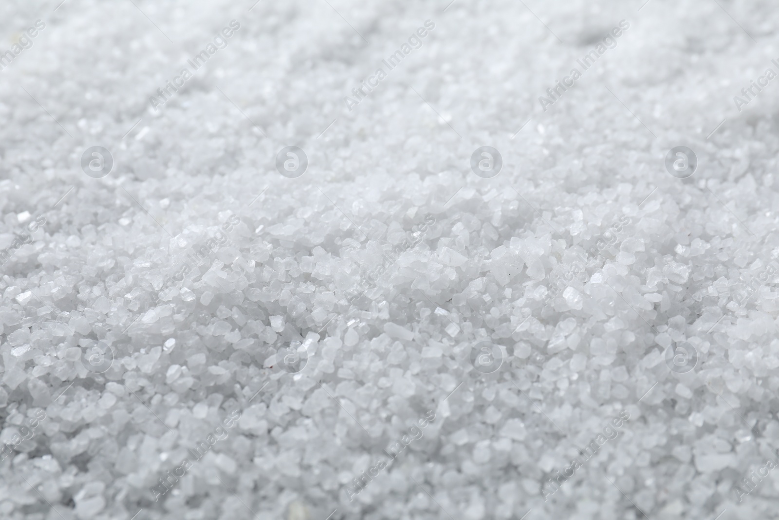 Photo of White natural salt as background, closeup view