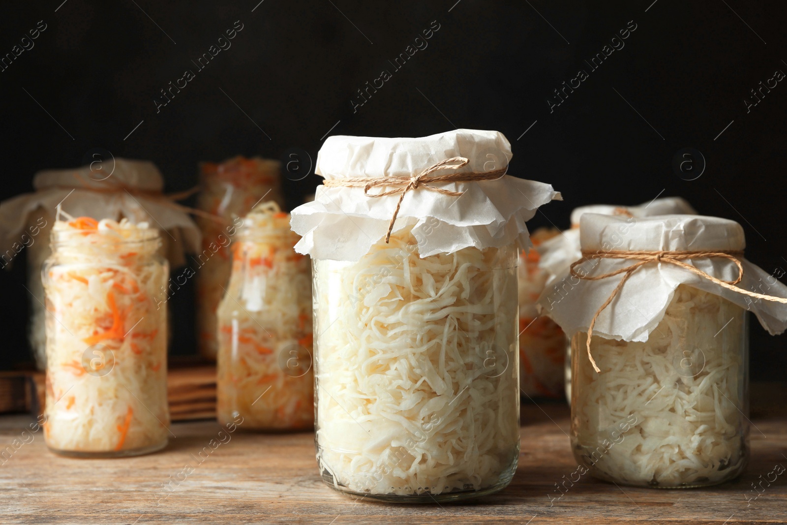 Photo of Tasty homemade fermented cabbage on wooden table