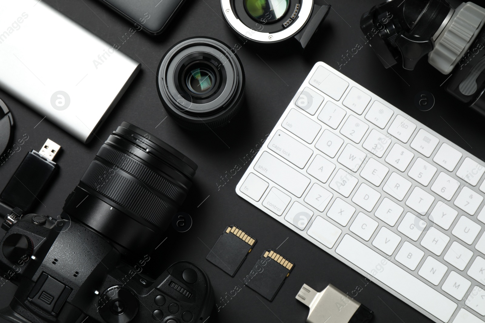 Photo of Camera, video production equipment and computer keyboard on black background, flat lay