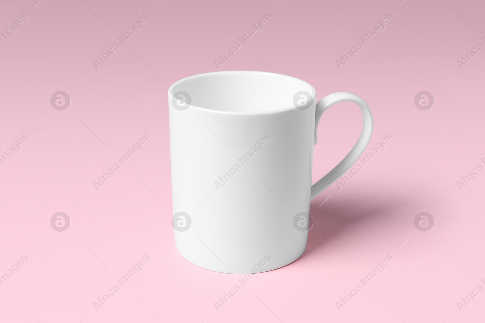 One white ceramic mug on pink background Photo of One white ceramic mug on pink background